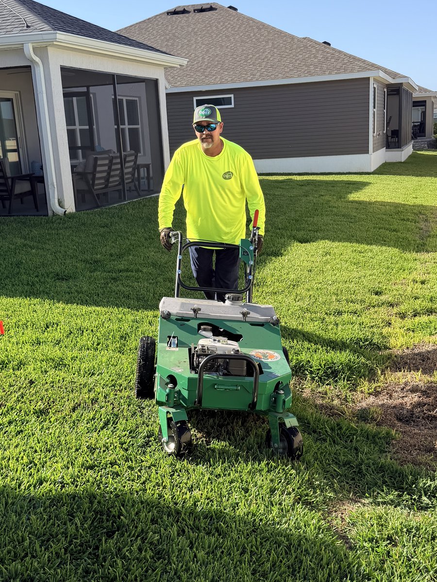 Tom O’Brien operating Oxford Lawn’s dethatching mower on a customer’s yard