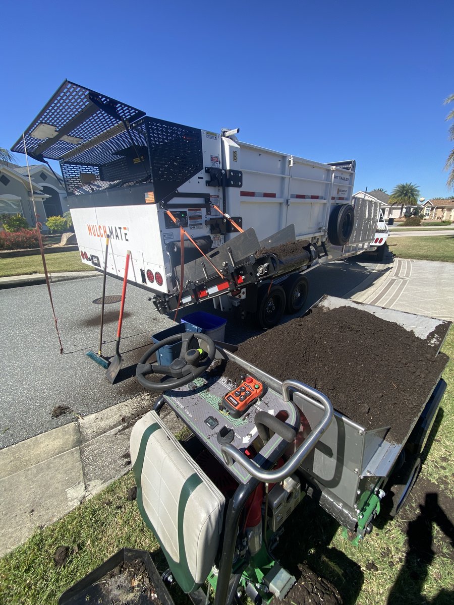 Oxford Lawn’s compost truck and self-propelled topdresser at a customer’s home